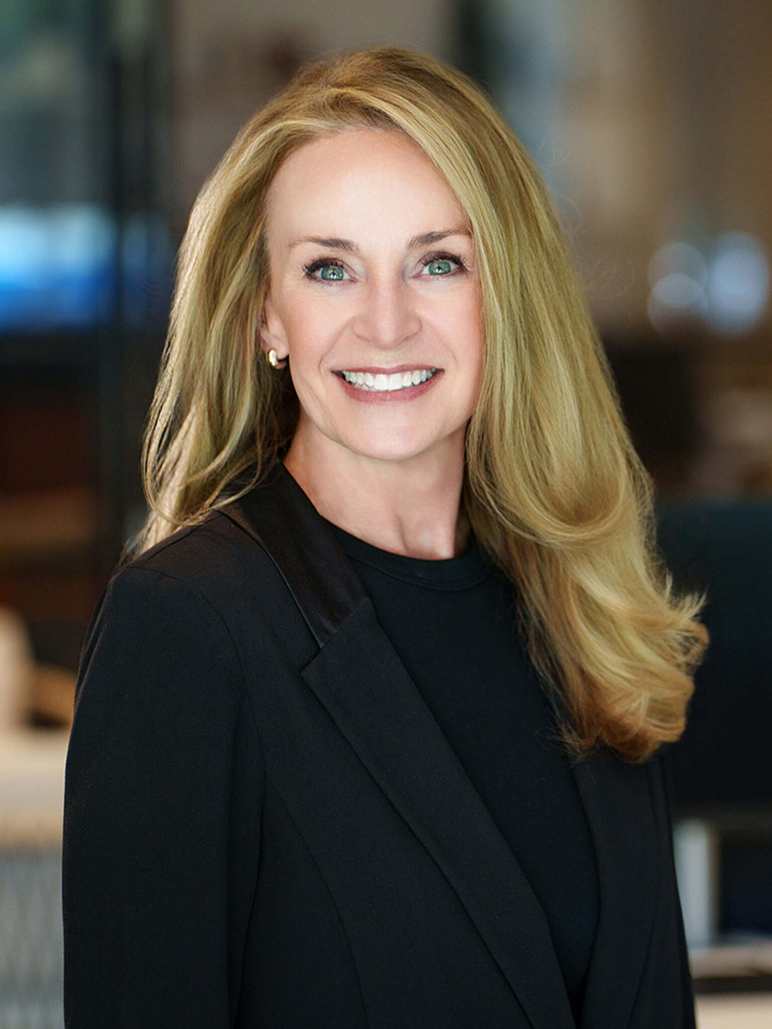 Woman with blonde hair smiling for a headshot