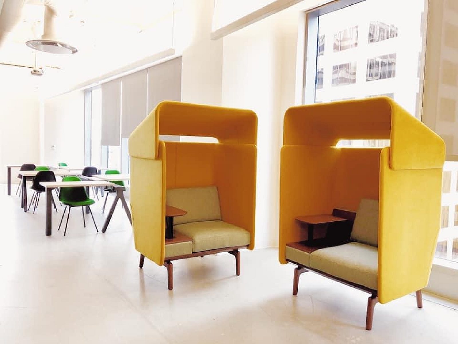two yellow lounge seats with classroom style desks in the background