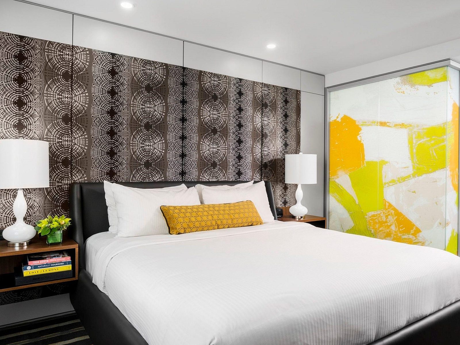 DIRTT Customizable Walls in a hotel room with a bed and two nightstands on either side