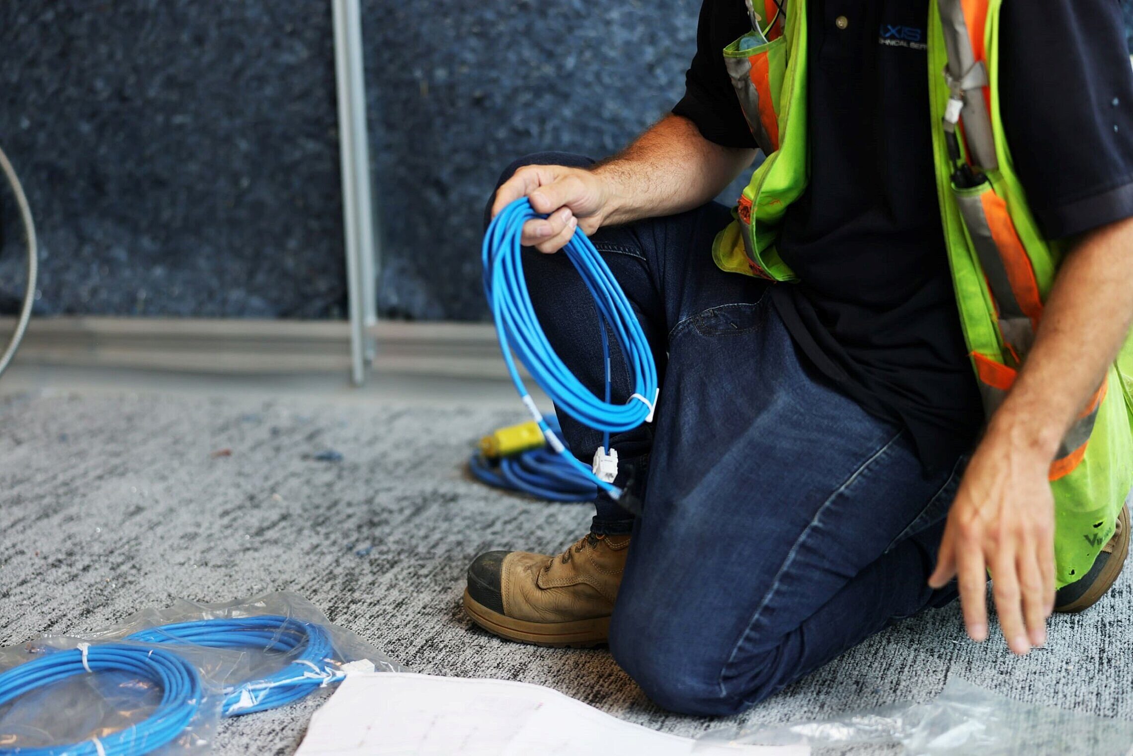 An installation technician holding wiring