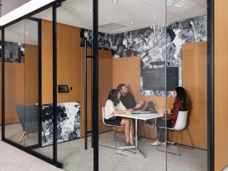 DIRTT Glass Walls surrounding a private office with a square white table and three white chairs