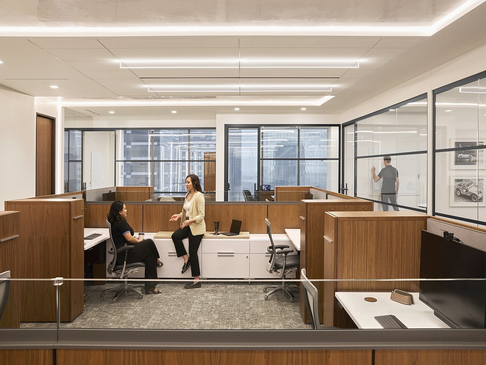 workstations with two chairs and two women talking