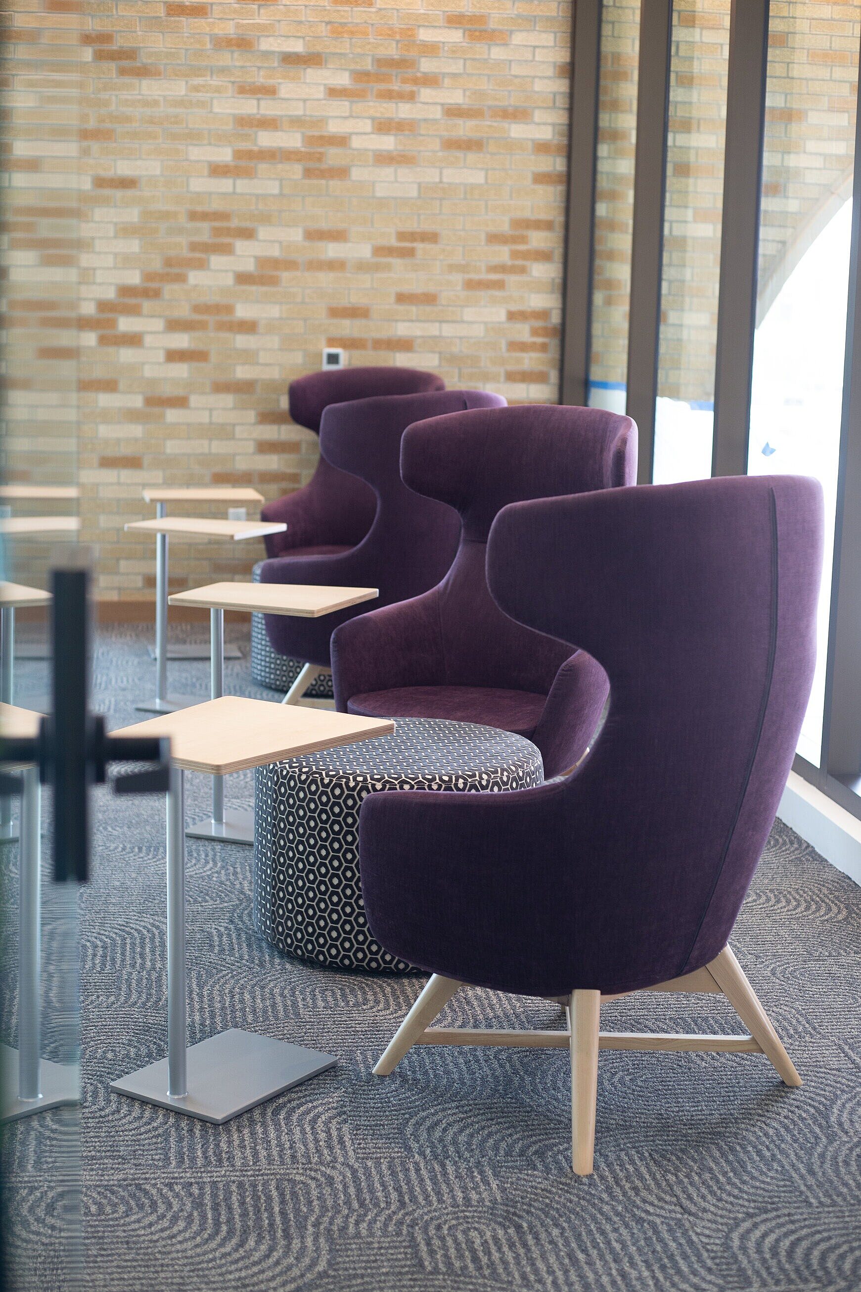 highback lounge chairs with laptop tables and ottomans