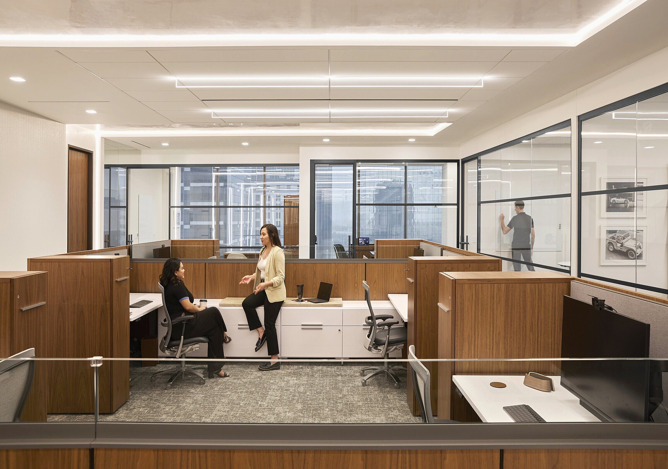 workstations with two chairs and two women talking