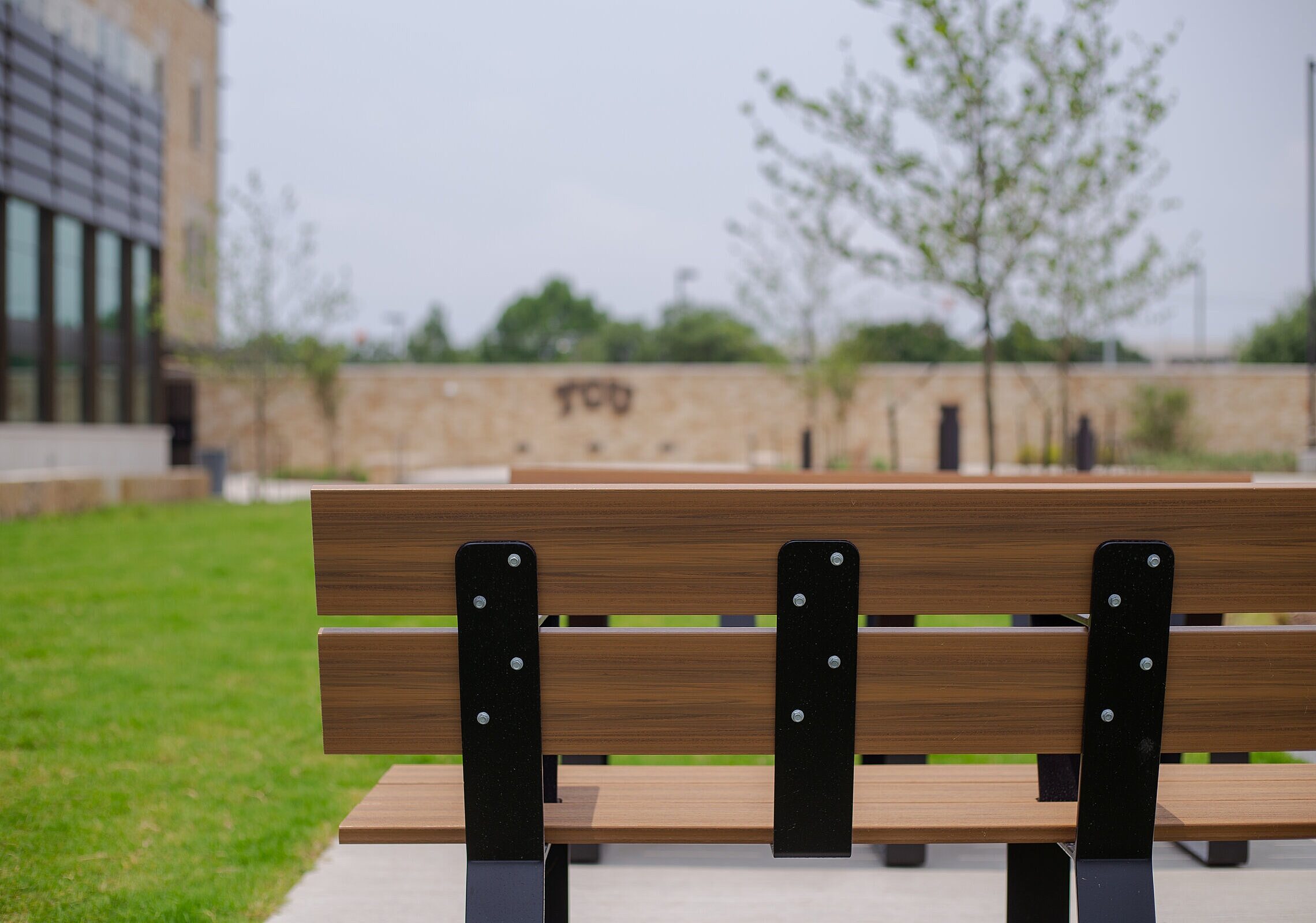 TCU Burnett School of Medicine outside of the building and the back of a wooden bench
