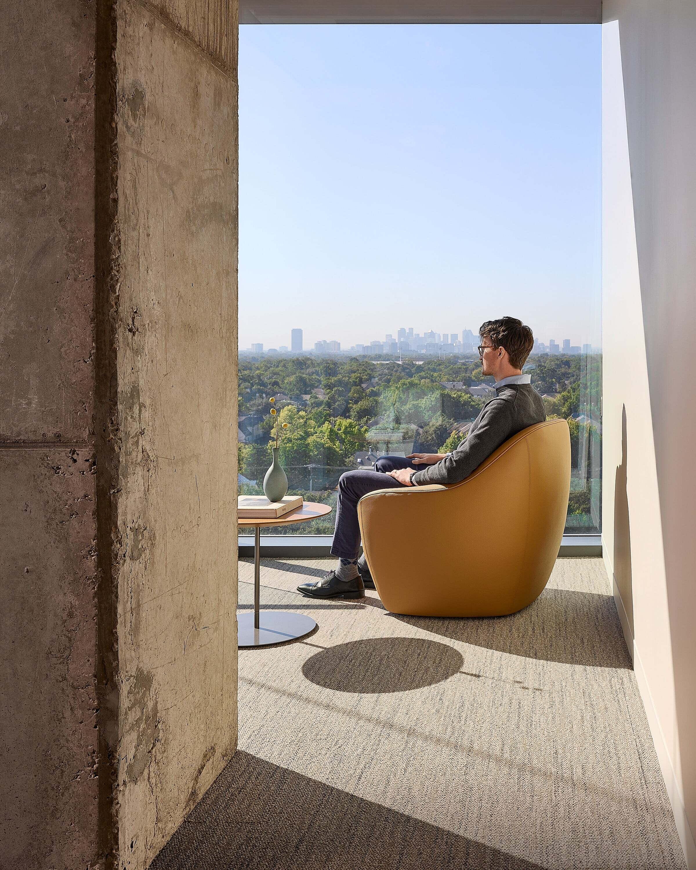 Wealth Management Company in Dallas Lounge Seating Area with a man sitting in a yellow lounge chair