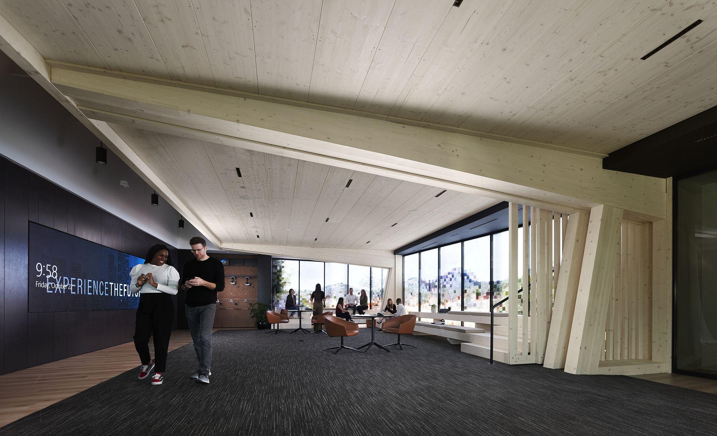 coworkers walking around the DIRTT Experience Center underneath DIRTT Timber wood structure
