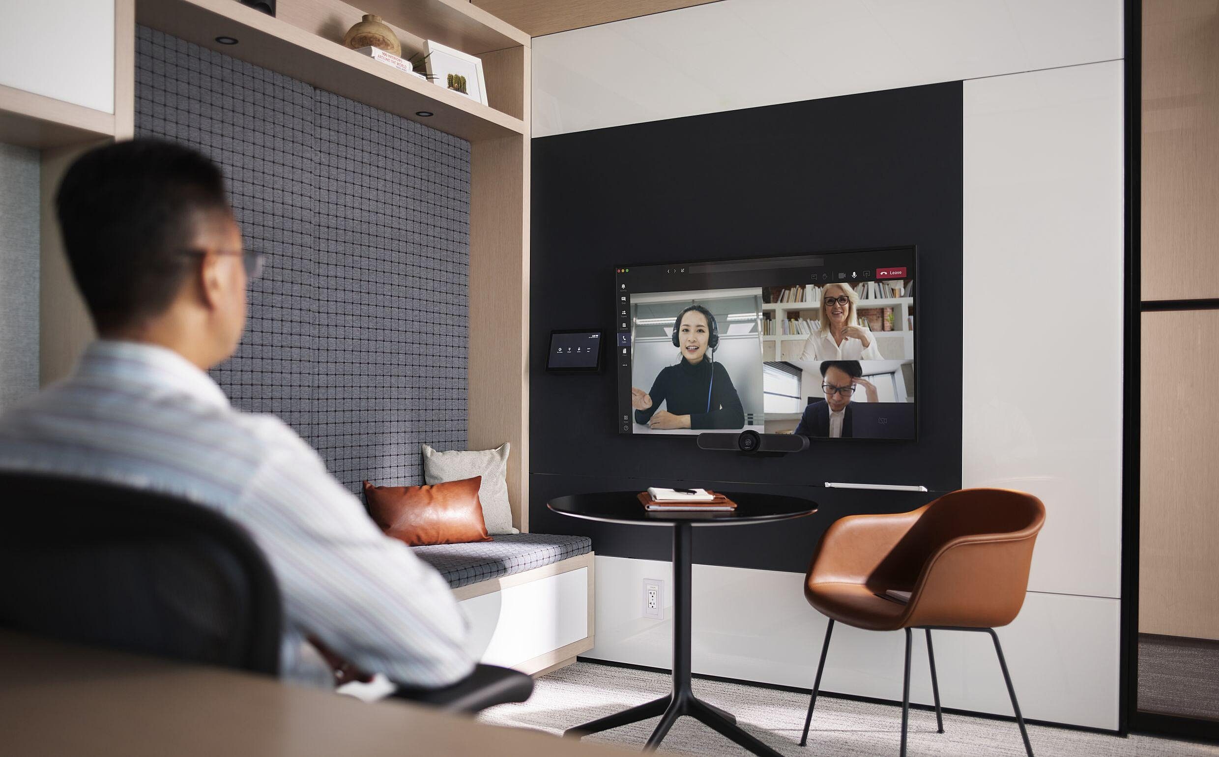 man sitting in a private office on a video call