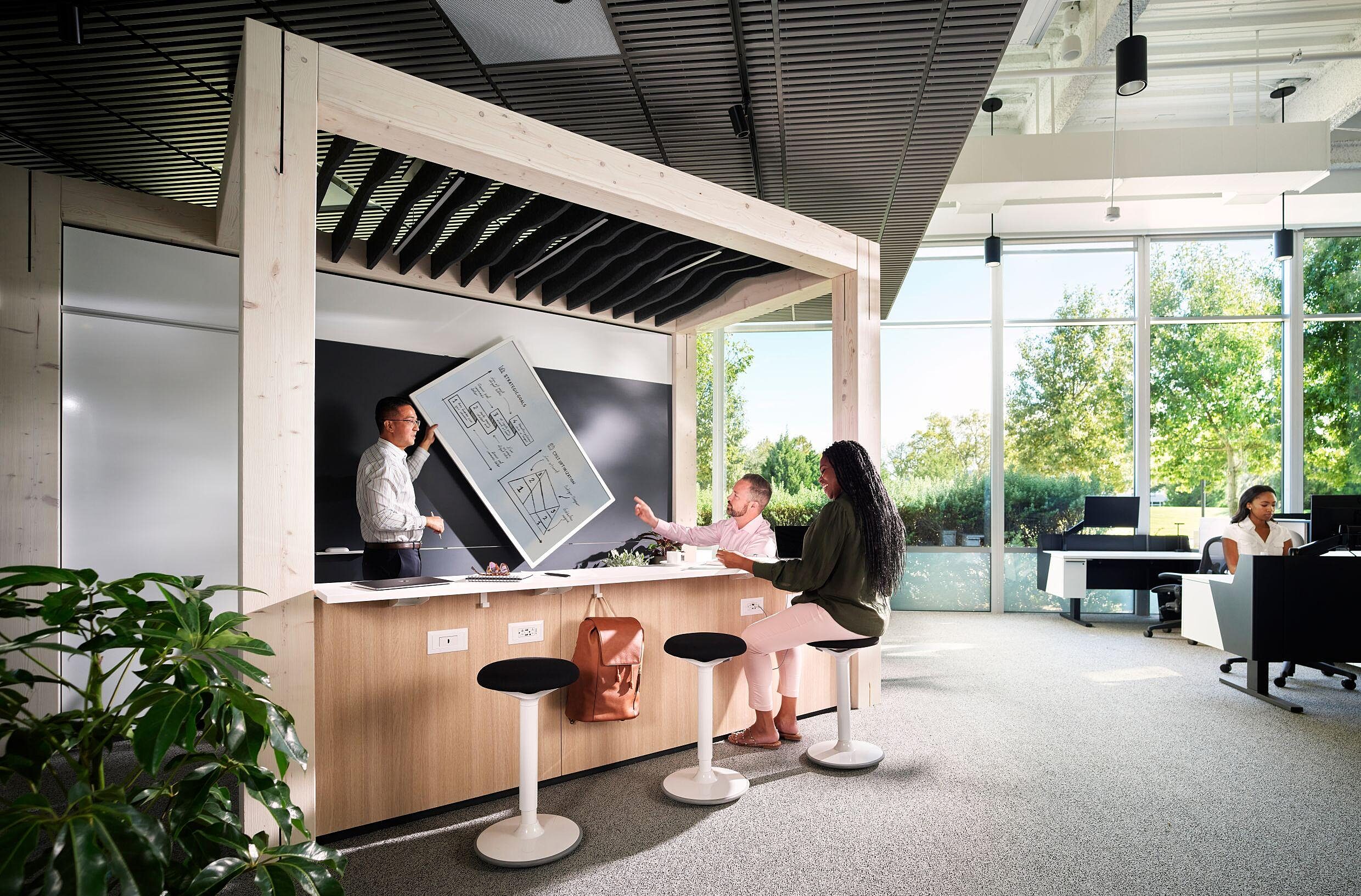 Coworkers meeting and collaborating under a DIRTT Timber wooden structure