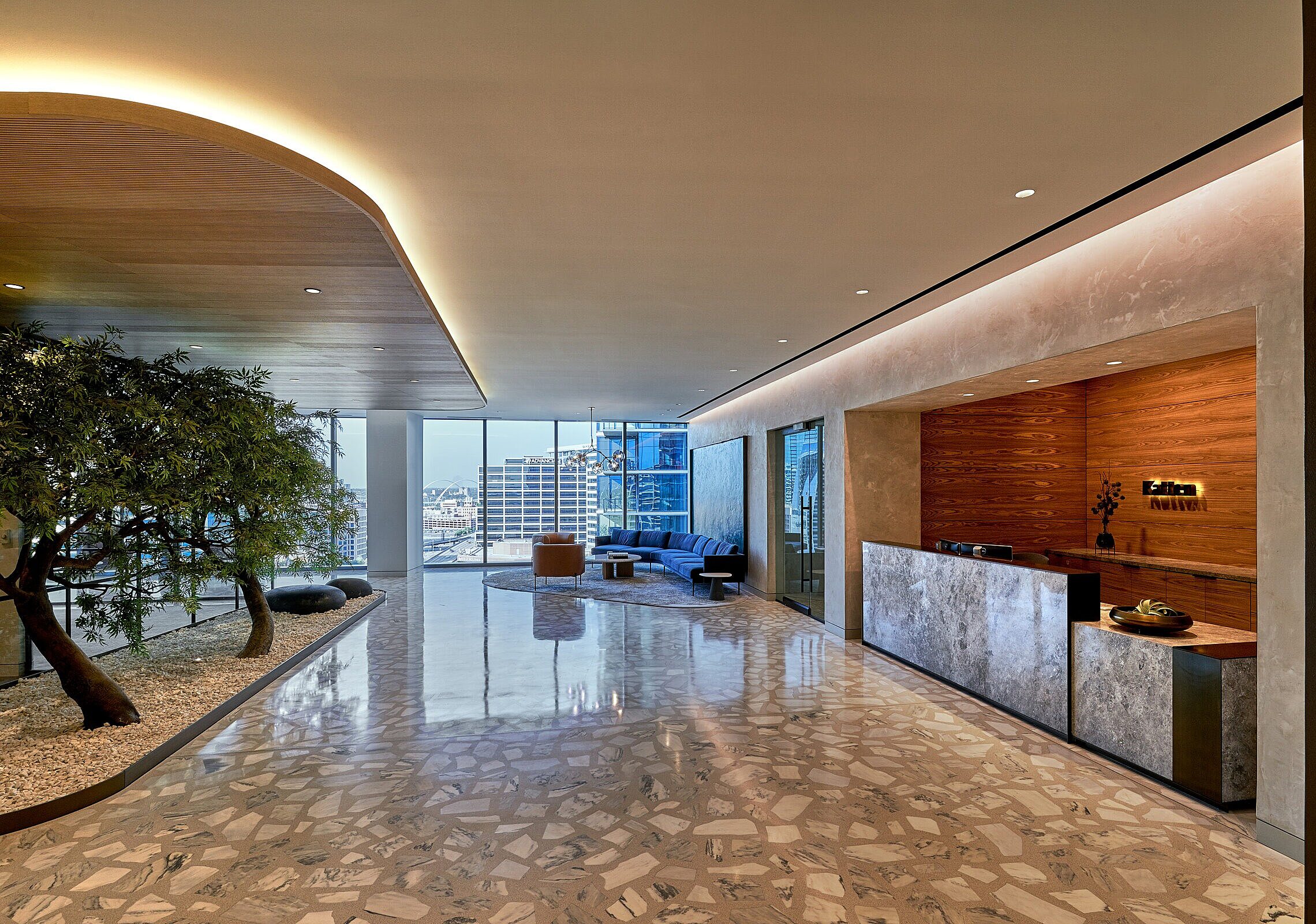 Katten law firm in Dallas lobby area with reception desk on the right hand side and trees on the left
