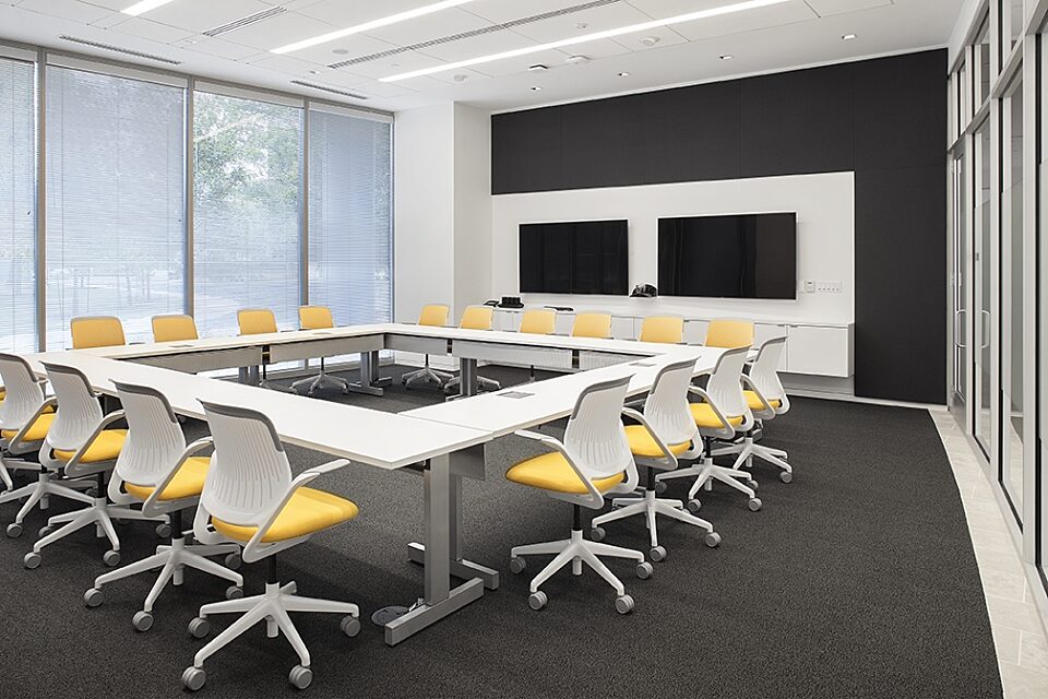 corporate office conference room with a large table and chairs