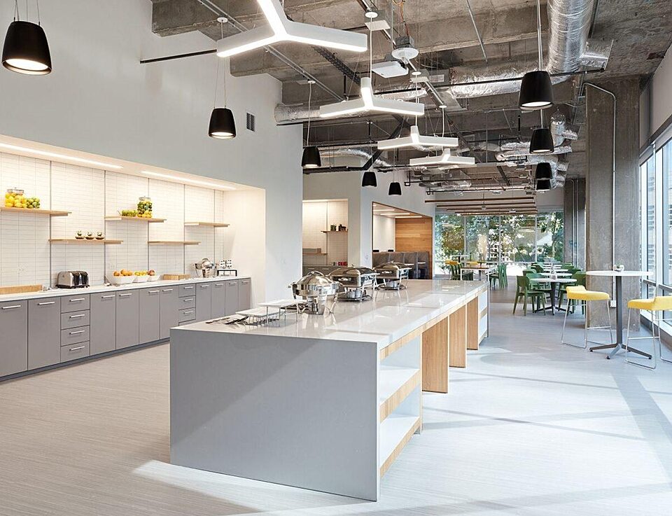 corporate office kitchen with large island and light fixtures