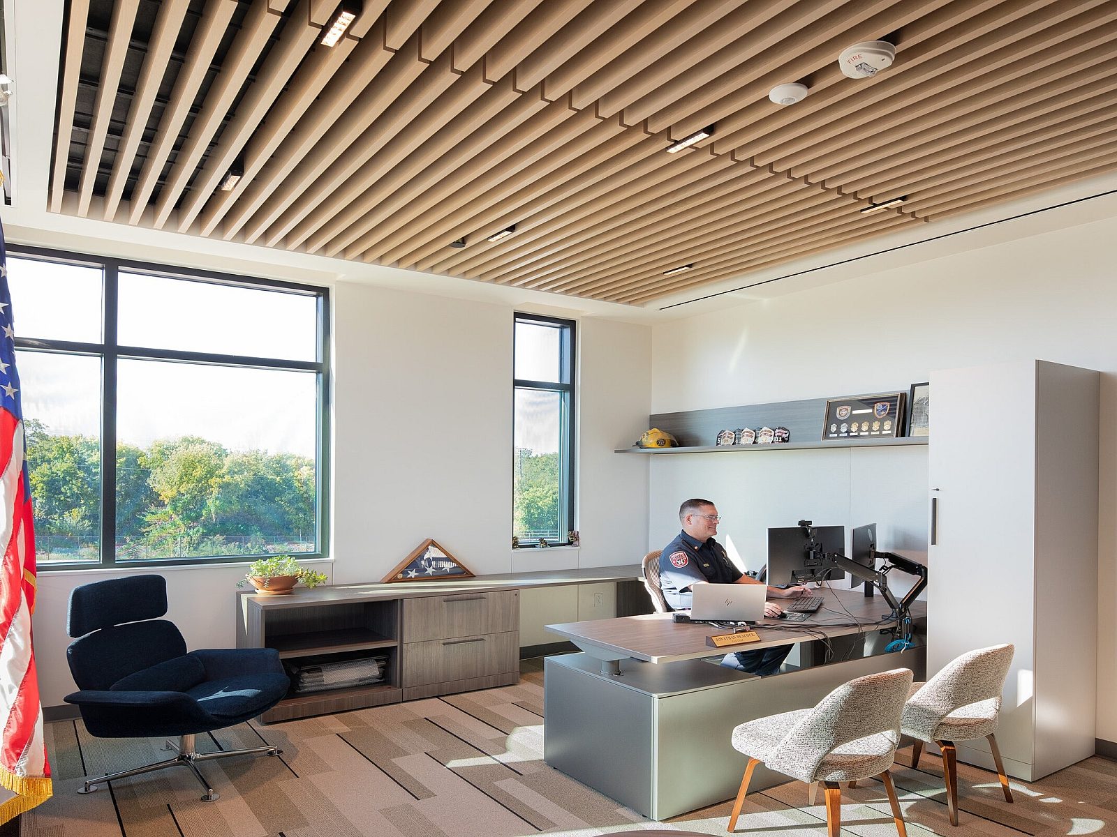 City of Weatherford Public Safety Building Chief's Office with a desk, monitor, lounge chair, two chairs, and the chief sitting at his desk