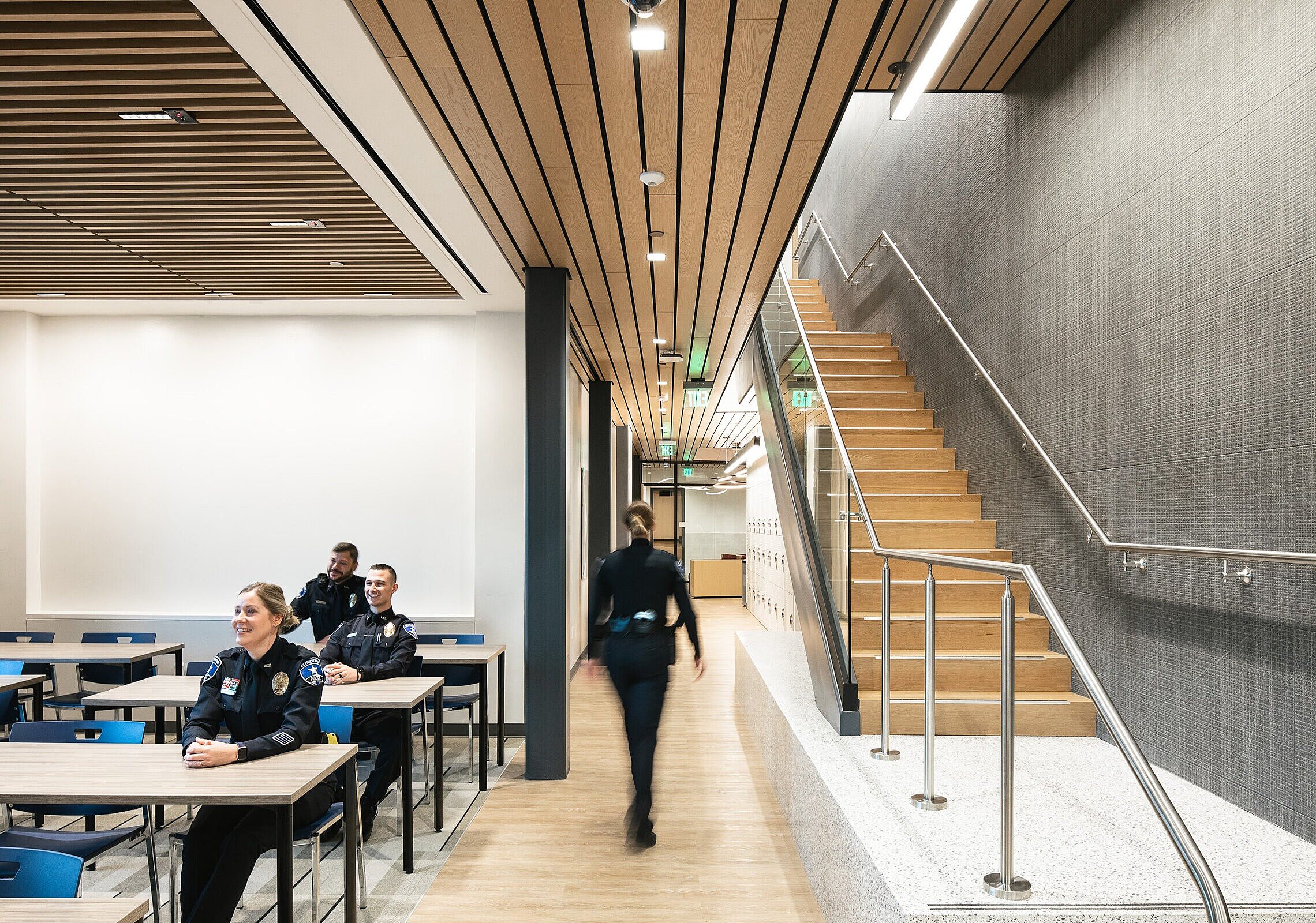 City of Weatherford Public Safety Building Briefing Room with long tables and blue chairs and a staircase on the right hand side