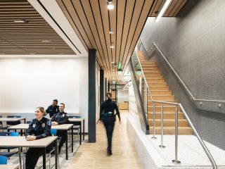 City of Weatherford Public Safety Building Briefing Room with long tables and blue chairs and a staircase on the right hand side